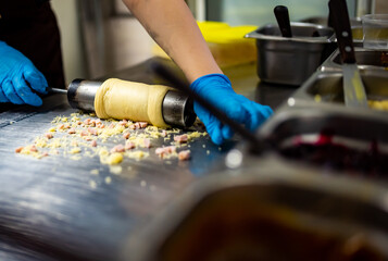 hand of chef baker making Trdlo or Trdelnik, Traditional tasty baked Czech Republic. street food