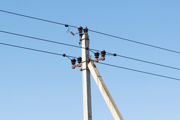 power line summer landscape, passing overhead electricity wire of the support carrying the light
