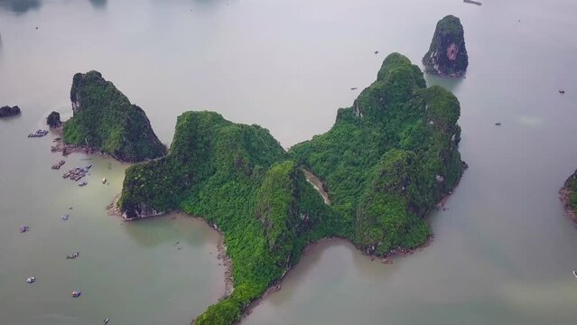 Aerial footage of Mystical Ha Long Bay in Vietnam. Flying over rocks sheer cliffs. Descending dragon. Best Travel tourism in Vietnam. High quality 4k footage Halong Bay.