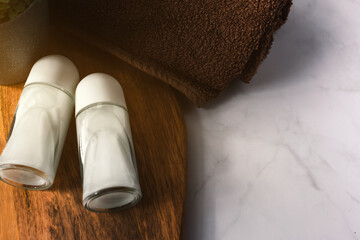 High angle view of new pair of deodorants for mockup on bath dreamy scenery. Bath still life with...