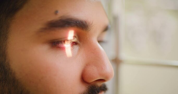 Closeup of a slit lamp machine testing a patients eye or pupil reflex during an optician consult. Headshot of a man visiting optometrist, using LED light to examine astigmatism and retina reflection
