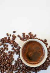 hot espresso and coffee beans arabica or robusta on white table with white background. top view
