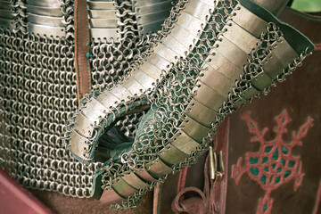 Vintage armor, retro chain mail and a protective metal glove. Ancient military arsenal of the...