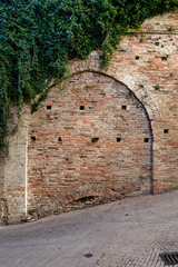 Antique arch close with bricks in Urbino, a medieval town in the Marche region of Italy