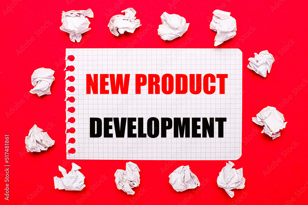Poster on a bright red background, white crumpled sheets of paper and a sheet of paper with the text new pr