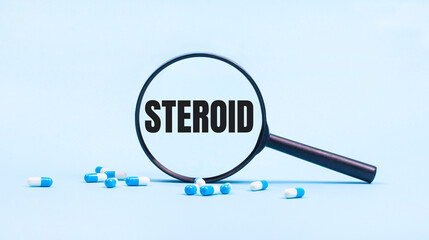 On a blue background, white and blue capsules with pills and a black magnifying glass with the text...