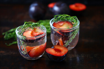 Detox drink with thyme and plum. Refreshing summer cocktail.