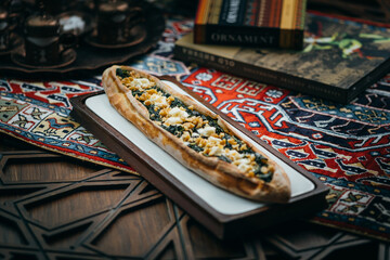 Pizza with meat and vegetables, Azerbaijani cuisine. Photography against a dark background