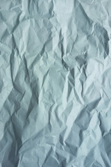 Gray crumpled a paper. Vertical photo. Background texture.