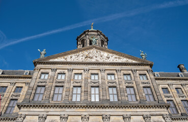 Fototapeta na wymiar Royal Palace Amsterdam at Dam Square, Holland Netherlands. Ornate building, sculpture. Under view