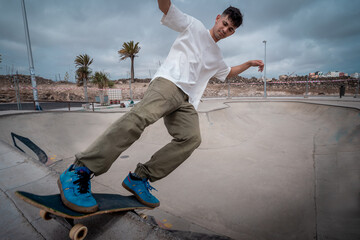 Young skateboarder male  in a skate park