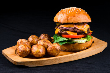 american burger set with french fries on a wooden board
