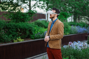 Portrait of man in virtual reality glasses. Guy in VR headset watching 3d movie, playing in VR games, enjoys virtual tour of tourist attractions. Businessman works in cyberspace.