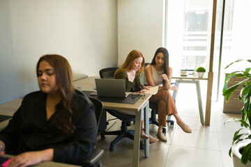 Female boss talking with a co-worker about a business project