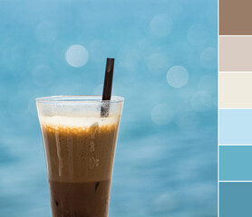 Color palette swatches of brown cold coffee frappe drink on blurred blue sea background. Pastel...
