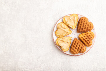 Homemade waffle with peanut butter on a gray concrete. top view, flat lay, copy space.