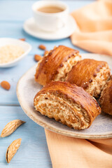 Traditional armenian dessert gata with cup of coffee on a blue wooden background. side view, close up, selective focus.