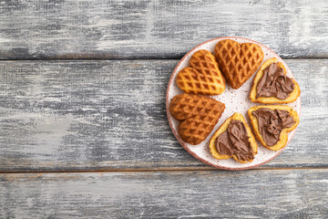 Homemade waffle with chocolate butter on a gray wooden. top view, flat lay, copy space.