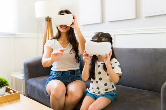Happy mother and kid wearing a virtual reality headset - Powered by Adobe