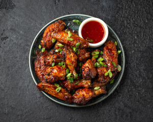 Baked chicken wings with spring onion and sweet chili sauce.