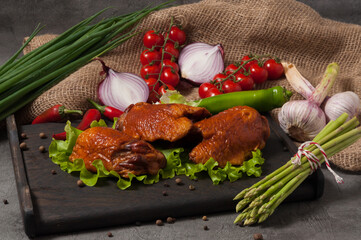 smoked chicken thigh, garnished with fresh vegetables