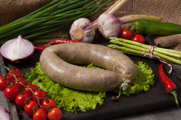 traditional liver sausage with liver decorated with fresh vegetables