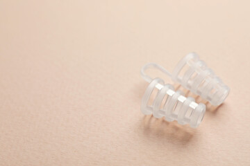 Nasal anti-snoring device on light background. Space for text