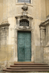 View of old building with wooden door. Exterior design
