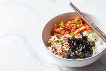 Kimchi tuna rice salad in white bowl. Traditional Korean food.
