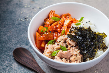 Kimchi tuna rice salad in white bowl. Traditional Korean food.