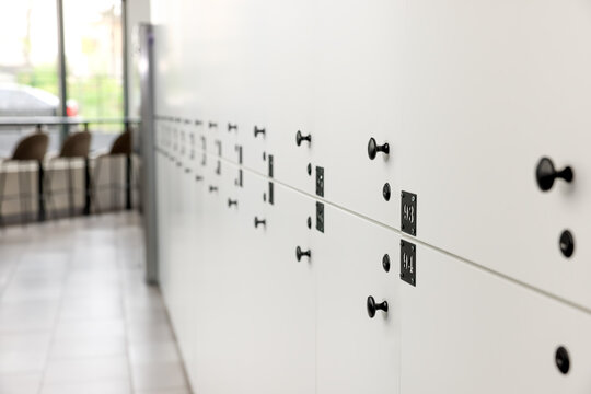 Rows of white lockers in modern hostel