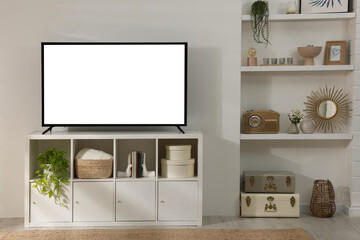 Modern TV set on stand in room