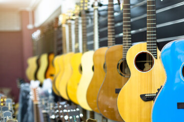 Guitars hanging in musical showroom at musical instrument store.