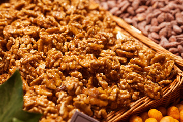 sweet walnut kernels in caramel glaze on counter in market