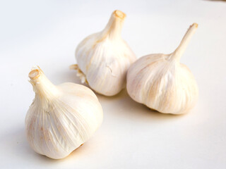 garlic heads and cloves on white background
