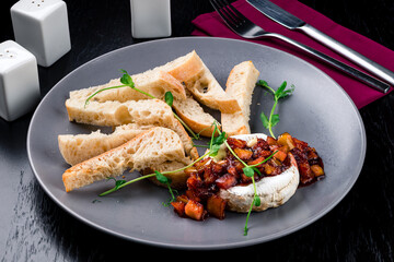 French camembert cheese baked in the oven served with croutons