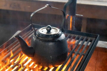Old kettle on the fire. Cooking in nature during a hike.