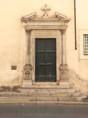 San Carlo alle Quattro Fontane Church Exterior Door with Sculpted Frame and Steps in Rome, Italy