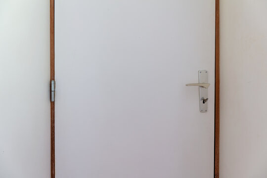closed interior door with metal handle and lock