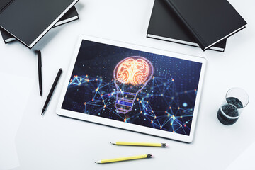 Creative light bulb with human brain hologram on modern digital tablet display, artificial Intelligence and neural networks concept. Top view. 3D Rendering