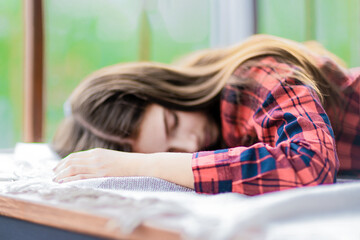Sleeping of a teen girl in red shirt.