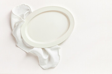 White empty plates on cotton dishcloth top view