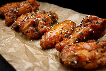 Grill chicken legs and wings on craft paper