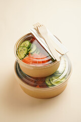 Trendy wholesome dish poke or buddha bowl - rice, wakame seaweed, tomatoes, cucumber, and red fish...