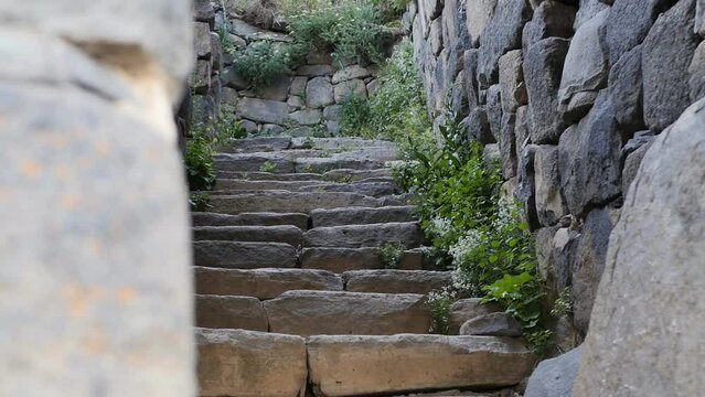 steps of a stone staircase and stone walls in an ancient, partially destroyed fortress with a thousand-year history. Armenian history and culture. Amberd