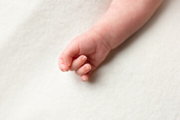 hand of a newborn baby. small pens. hands on white background