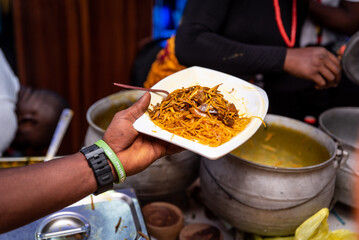 A plate of Abacha (African Salad) being served to a guest.