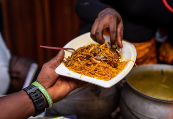 A plate of Abacha (African Salad) being served to a guest.