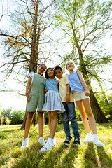 Fototapeta premium Group of asian and caucasian kids having fun in the park