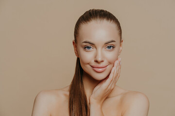 Photo of lovely young woman has smooth healthy skin after beauty procedures and receiving facial...